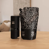 Black ONNYBODY Dispenser sitting next to ONNYBODY 2 litre refill pouch