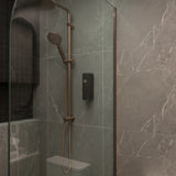 One black ONNYBODY dispenser attached to a tiled bathroom wall next to a shower head.
