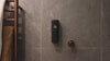 ONNYBODY dispenser attached to wall getting filled with ONNYBODY body wash 